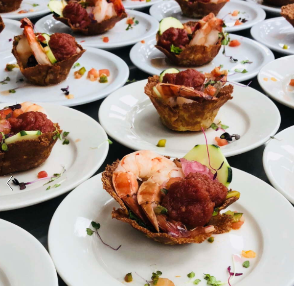 Shrimp appetizers on white plates 